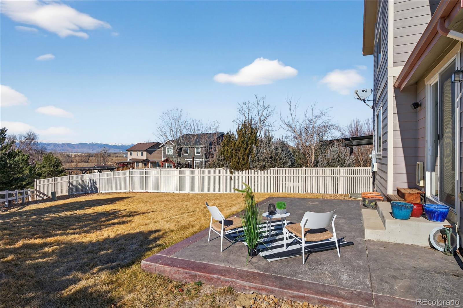10180 Audrey Street Firestone, CO 80504 - Photo 36 of 46 a view of a swimming pool with a patio and a yard