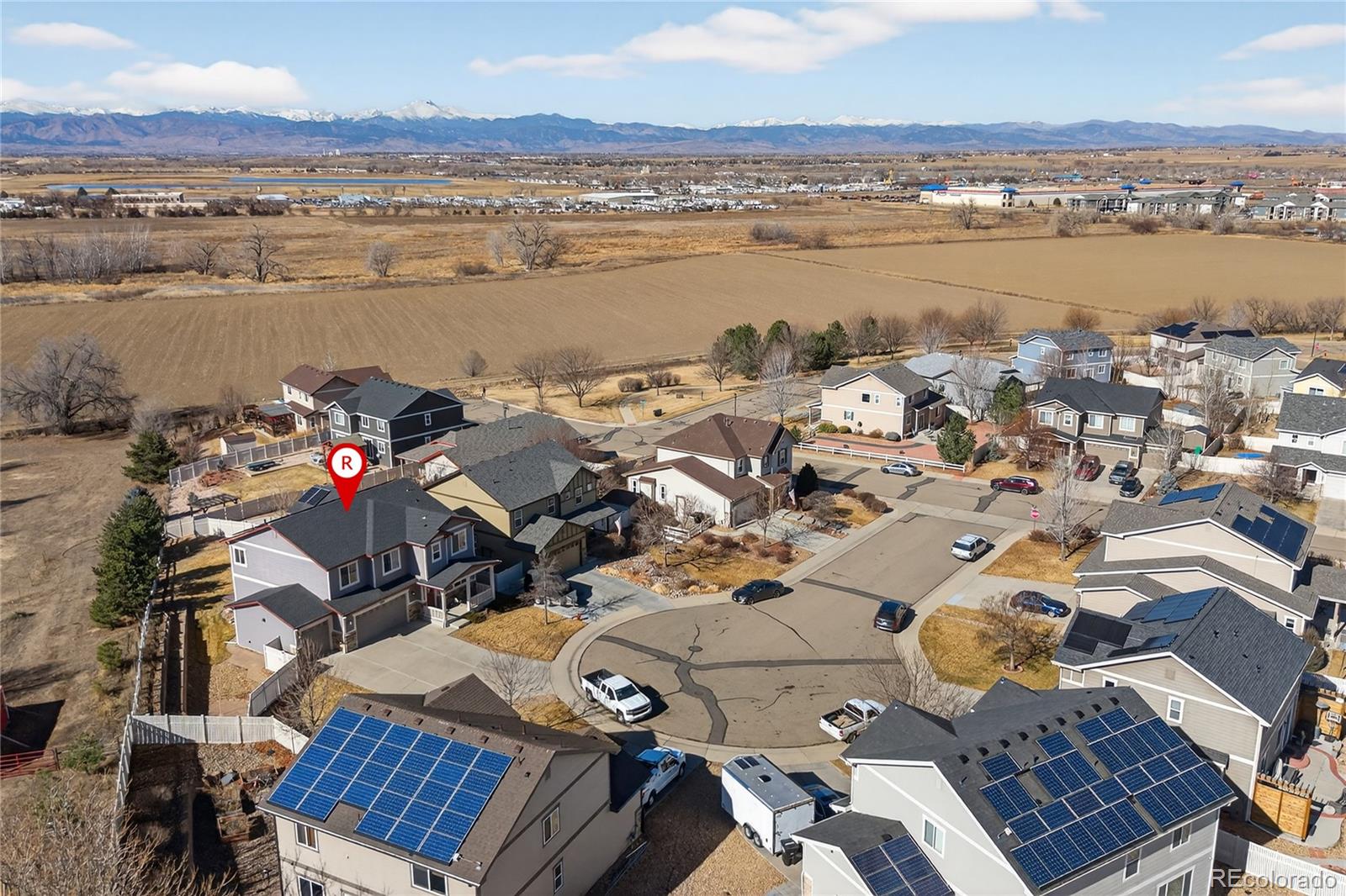 10180 Audrey Street Firestone, CO 80504 - Photo 43 of 46 an aerial view of a city with lots of residential buildings ocean and mountain view in back