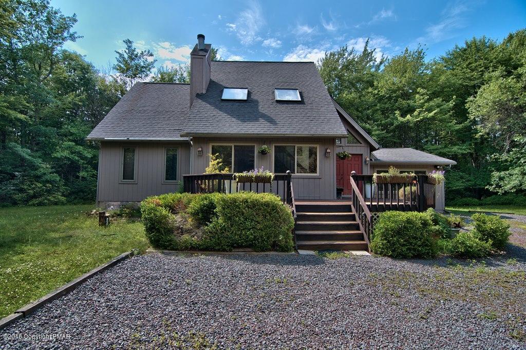 131 Powderhorn Road Long Pond, PA 18334 - Photo 2 of 54 a front view of a house with a garden