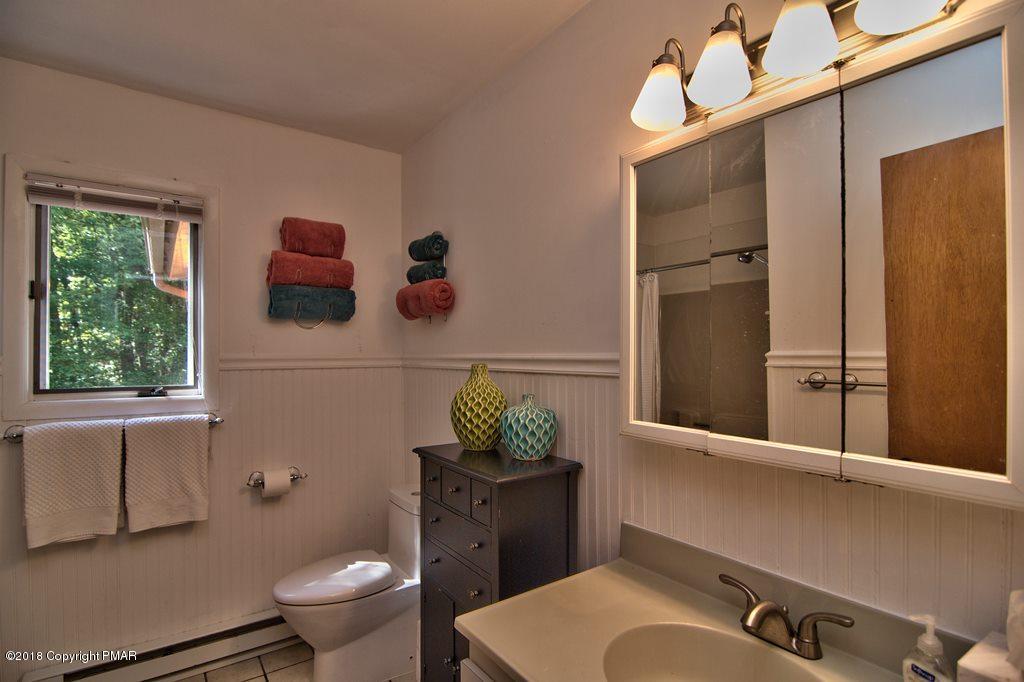 131 Powderhorn Road Long Pond, PA 18334 - Photo 34 of 54 a bathroom with a sink mirror vanity and toilet
