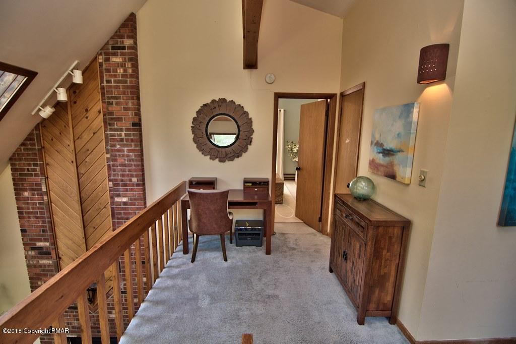 131 Powderhorn Road Long Pond, PA 18334 - Photo 41 of 54 a view of a hallway to a livingroom with furniture and stairs
