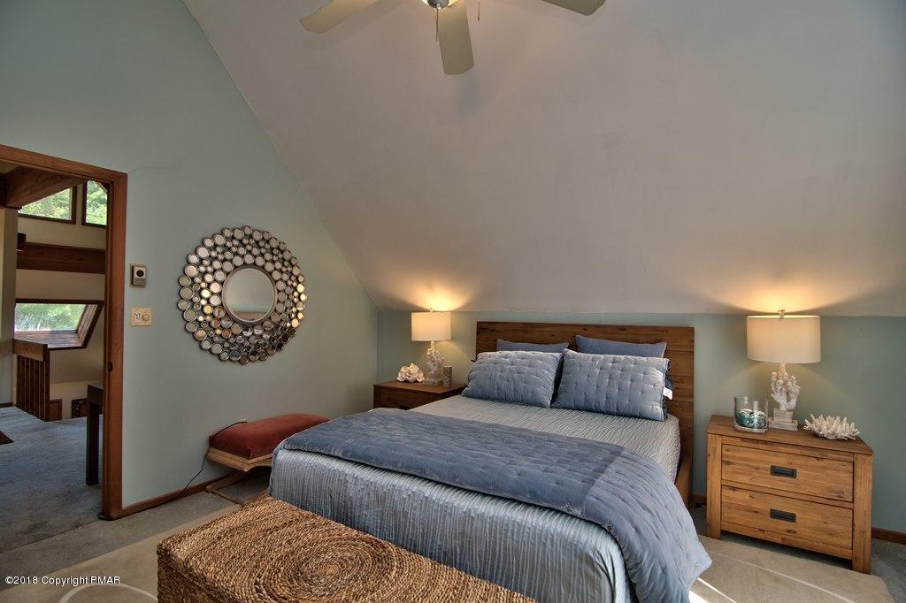 131 Powderhorn Road Long Pond, PA 18334 - Photo 44 of 54 a bedroom with a bed and a lamp on dresser