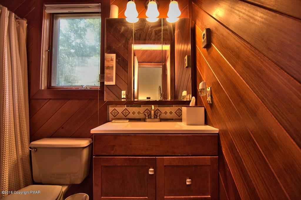 131 Powderhorn Road Long Pond, PA 18334 - Photo 47 of 54 a bathroom with a toilet a sink and mirror