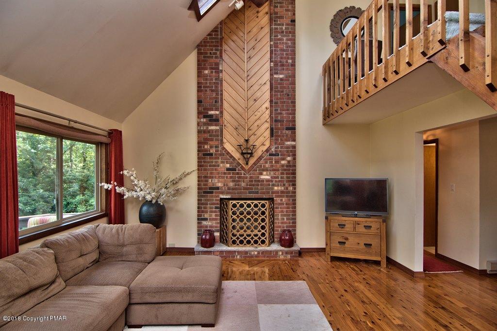 131 Powderhorn Road Long Pond, PA 18334 - Photo 8 of 54 a living room with furniture and a fireplace