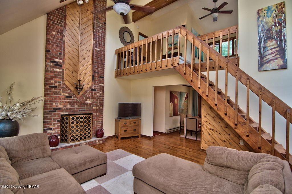 131 Powderhorn Road Long Pond, PA 18334 - Photo 9 of 54 a living room with furniture or stairs and a fireplace