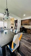 a kitchen with stainless steel appliances granite countertop a sink a stove and a wooden cabinets