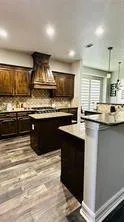 a kitchen with stainless steel appliances granite countertop a sink counter space and cabinets