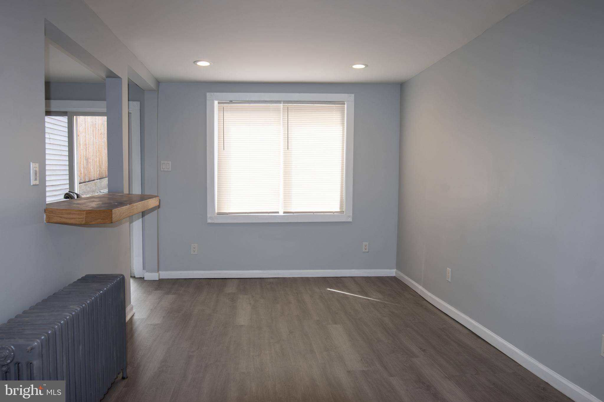 321 North 3rd Street Pottsville, PA 17901 - Photo 11 of 40 an empty room with wooden floor and windows