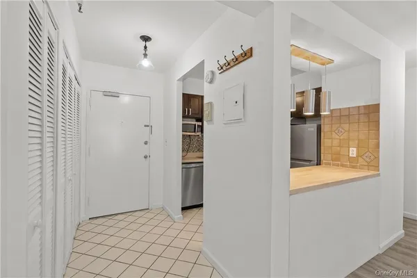 a view of a hallway with wooden shelves