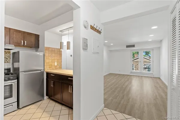 a kitchen with stainless steel appliances granite countertop a refrigerator and a sink