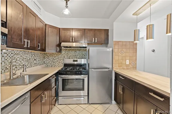 a kitchen with a sink appliances and cabinets