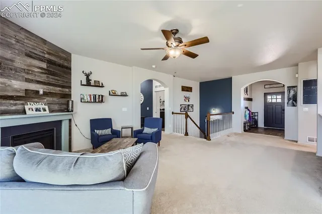 a living room with furniture and a fireplace