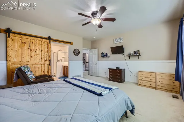 a bedroom with a large bed and a large window