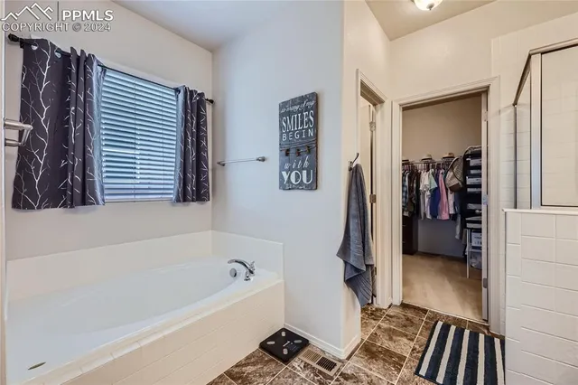 a bathroom with a tub and a shower