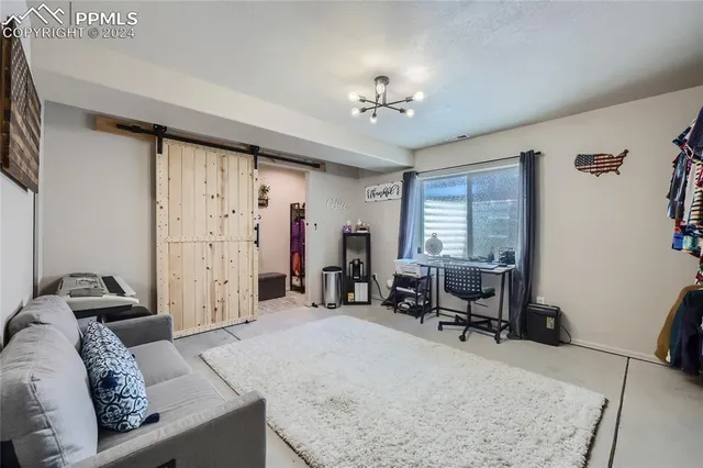 a view of a livingroom with furniture and a window