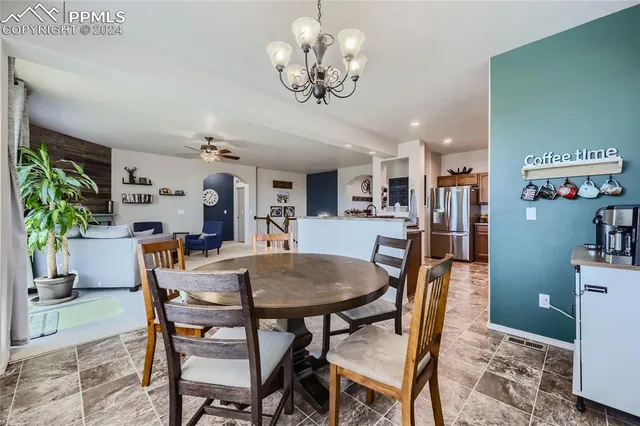 a view of a dining room with furniture and a chandelier
