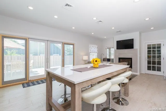 a view of a dining room with furniture and a flat screen tv