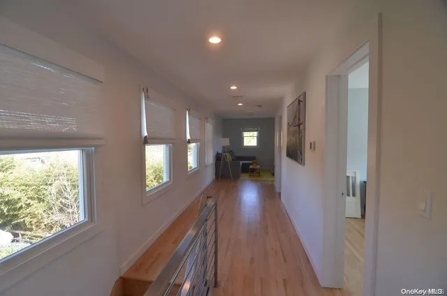a view of hallway with wooden floor