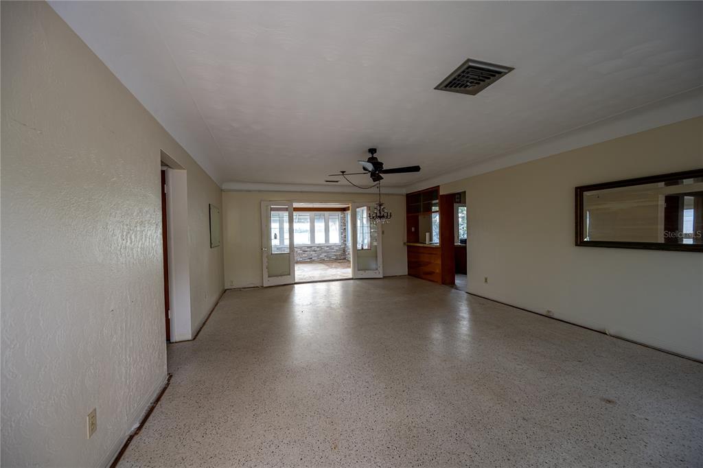 1425 Corey Way South South Pasadena, FL 33707 - Photo 16 of 34 an empty room with windows and ceiling fan