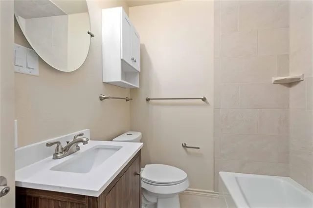 a bathroom with a sink toilet and a mirror