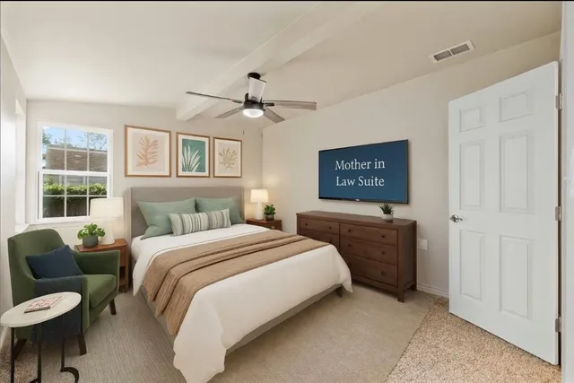 a bedroom with a bed a window and a chandelier