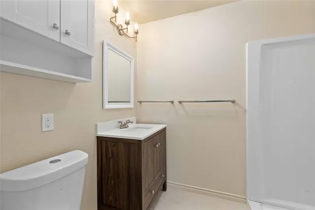 a bathroom with a toilet a sink and a mirror