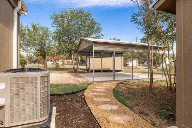 a view of backyard with patio