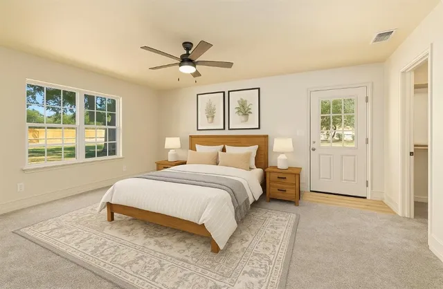 a bedroom with a large bed and a window