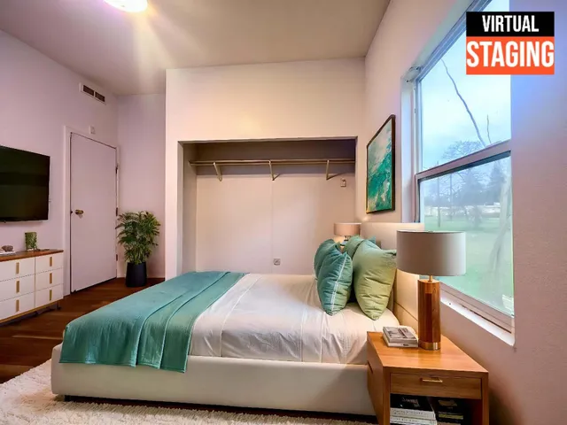 a bedroom with a bed window and potted plant