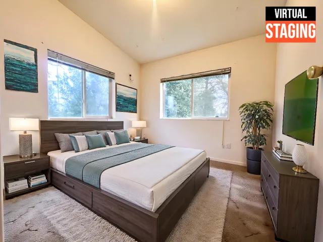 a bedroom with a large bed and a flat tv screen on dresser