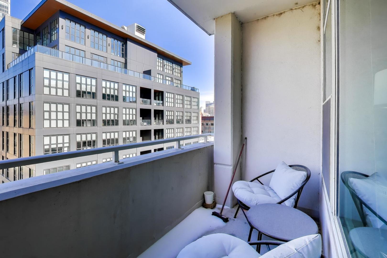 909 West Washington Boulevard, Unit 811 Chicago, IL 60607 - Photo 15 of 28 a balcony view with chair and table