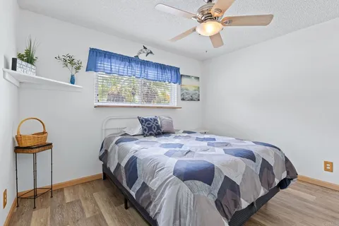 a bedroom with a bed and a chandelier