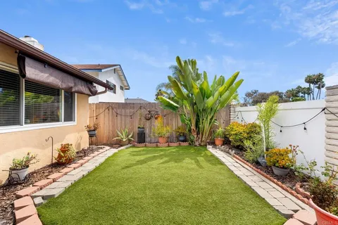a front view of a house with a garden and yard