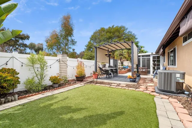 a view of a patio with table and chairs under an umbrella