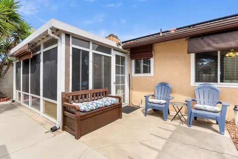 a view of a porch with dining table and chairs