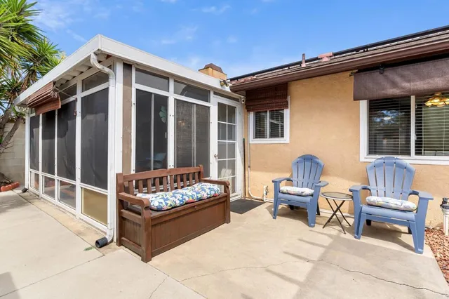 a view of a porch with dining table and chairs