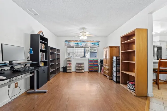 a view of a kitchen with furniture and an empty room