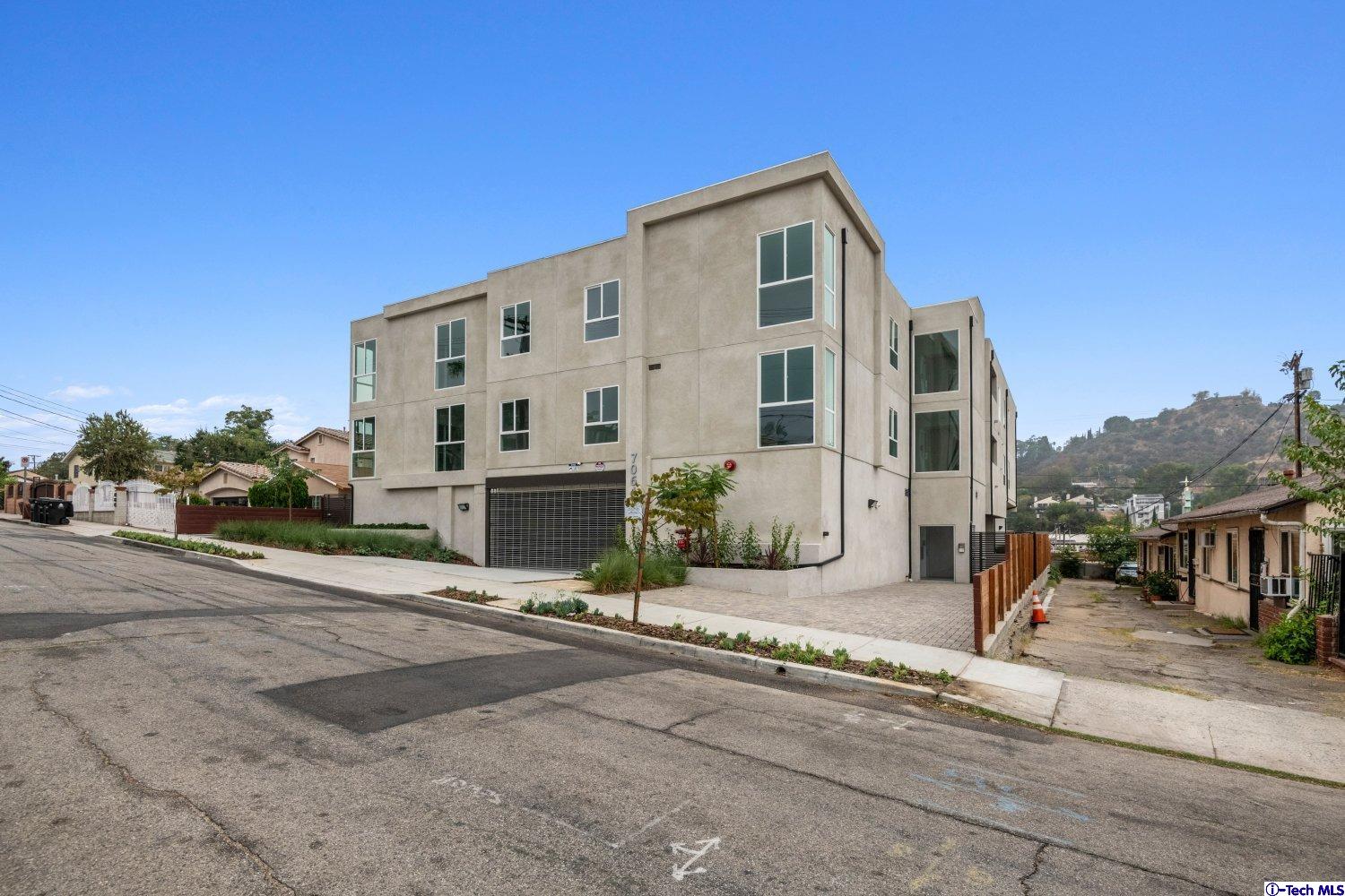7064 Greeley Street, Unit 101 Tujunga, CA 91042 - Photo 2 of 37 a front view of a building with street view