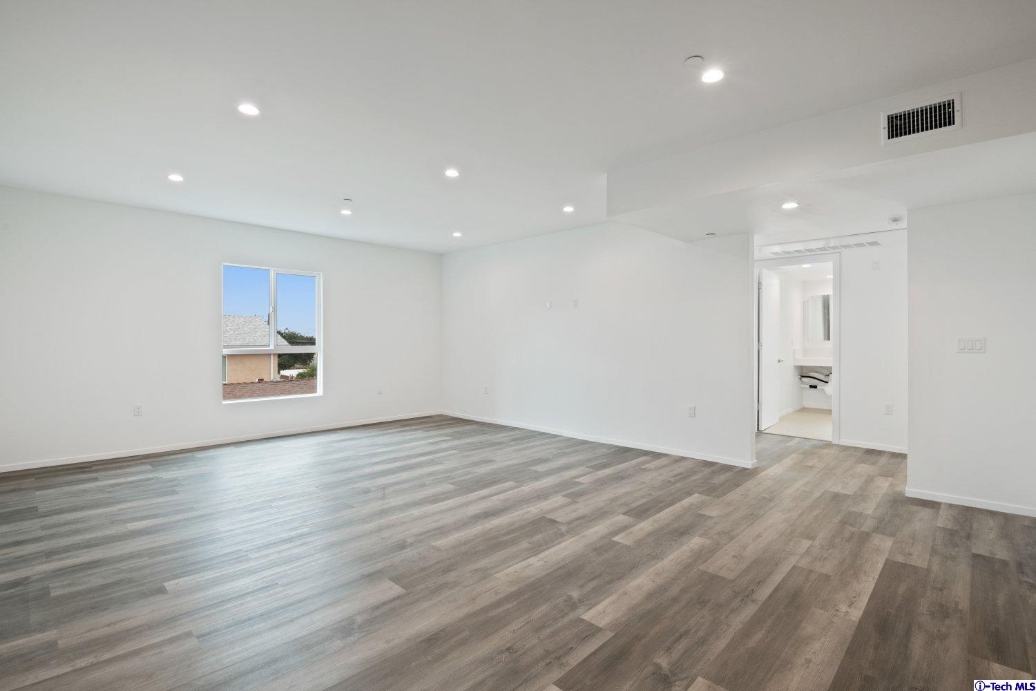 7064 Greeley Street, Unit 101 Tujunga, CA 91042 - Photo 16 of 37 a view of empty room with wooden floor