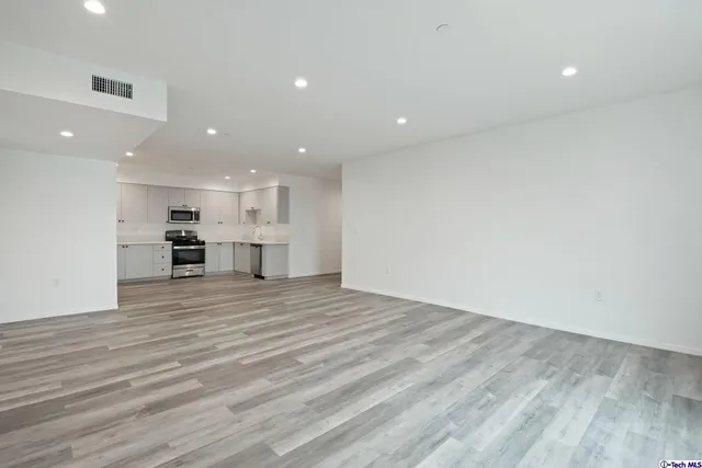 a kitchen with stainless steel appliances granite countertop a sink and cabinets