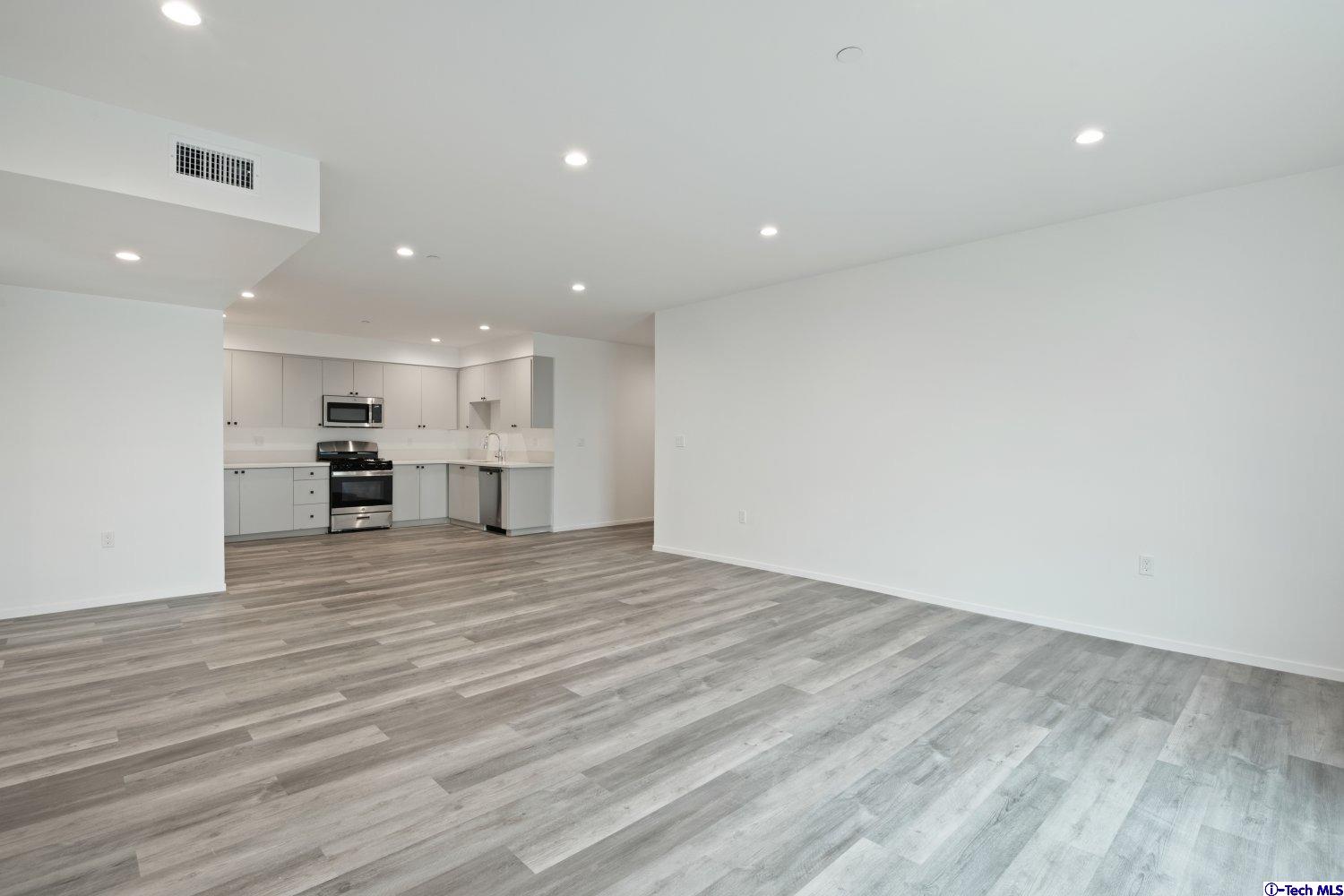 7064 Greeley Street, Unit 101 Tujunga, CA 91042 - Photo 18 of 37 a view of kitchen and kitchen with a wooden floor