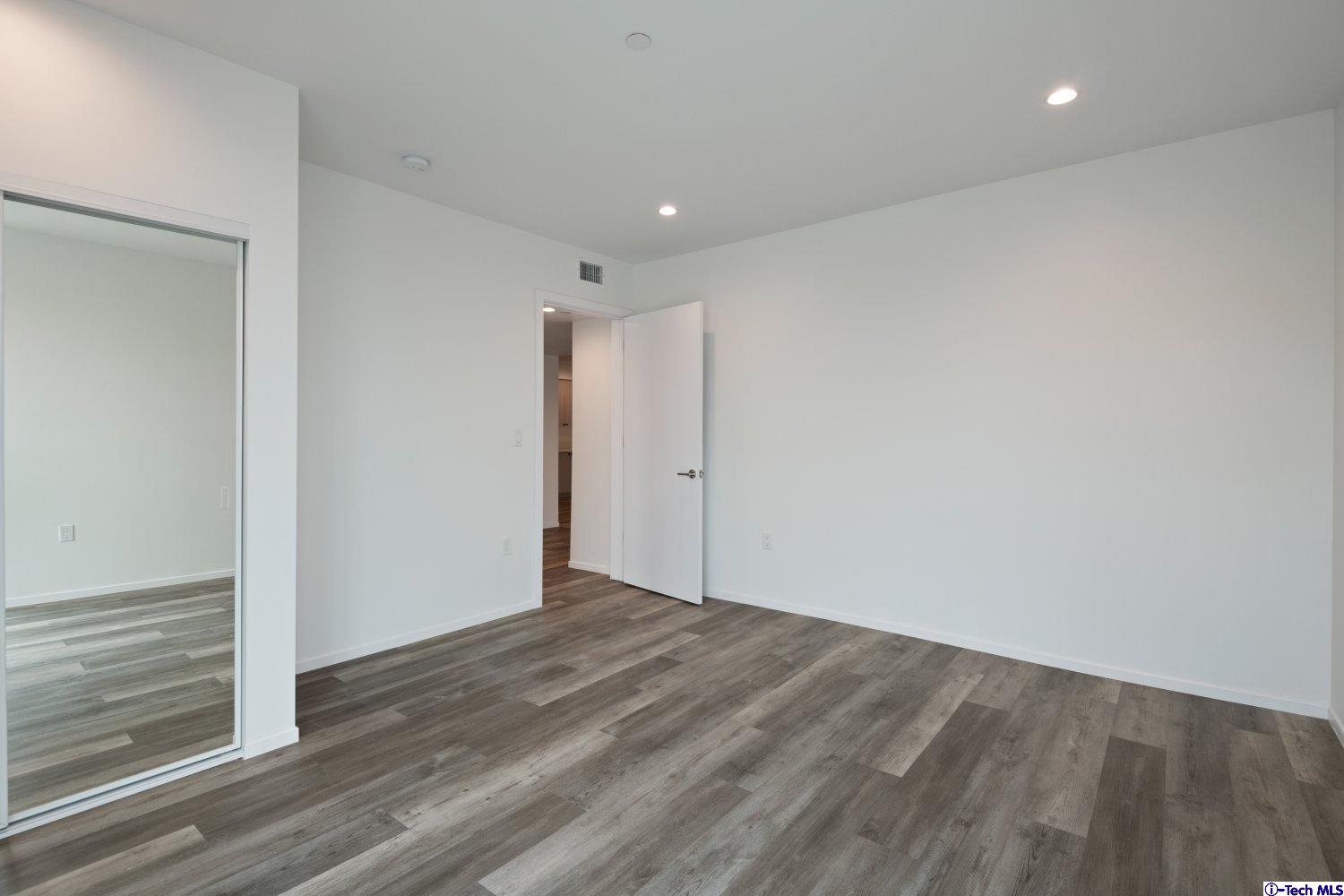 7064 Greeley Street, Unit 101 Tujunga, CA 91042 - Photo 27 of 37 a view of hallway with wooden floor