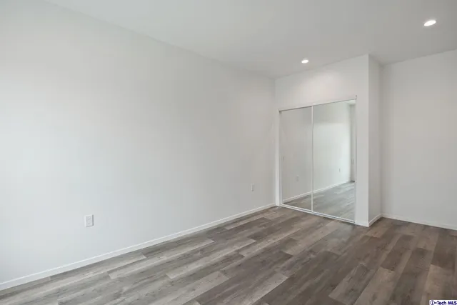 a view of a house with a yard and potted plants