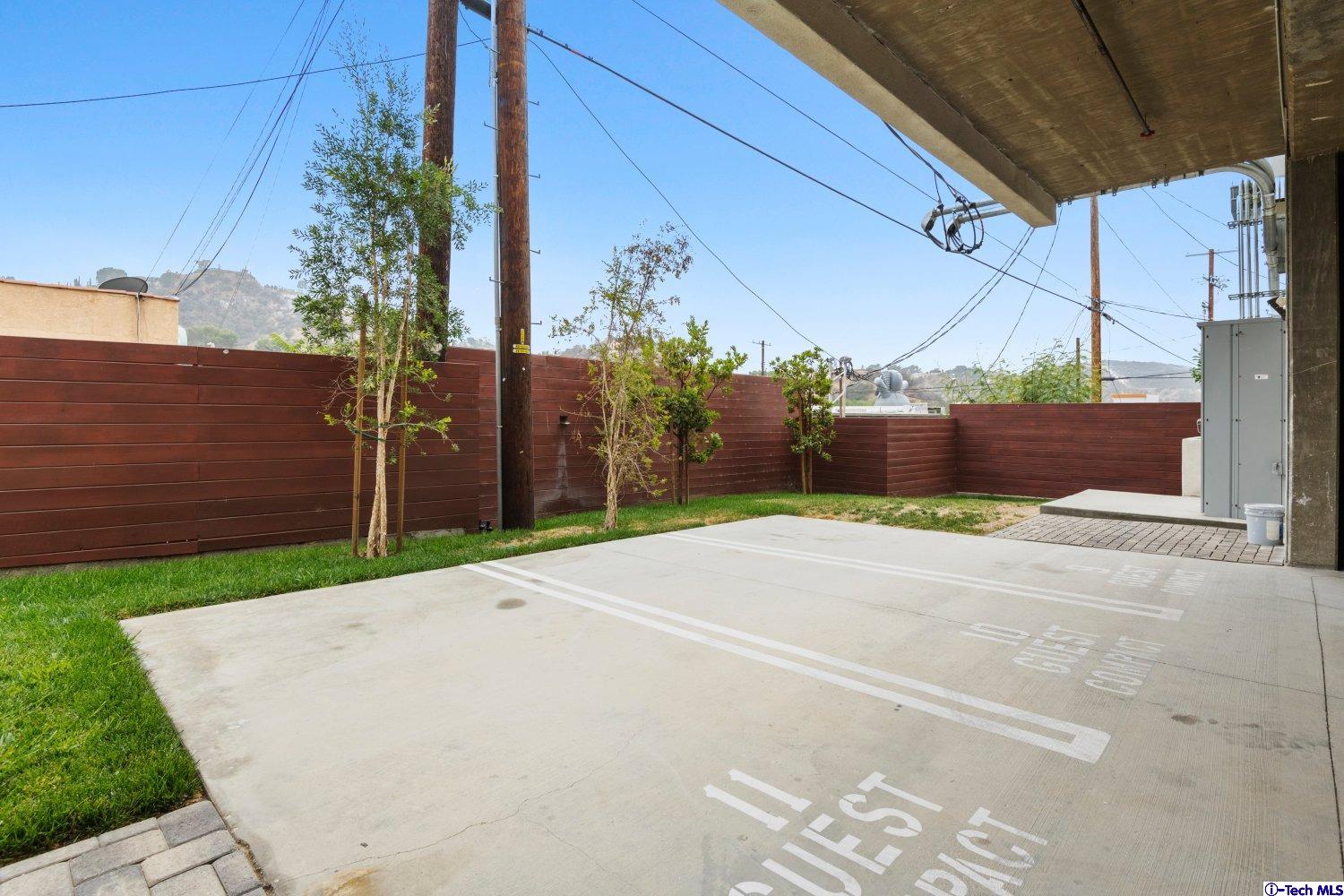 7064 Greeley Street, Unit 101 Tujunga, CA 91042 - Photo 33 of 37 a view of a street with a building in the background