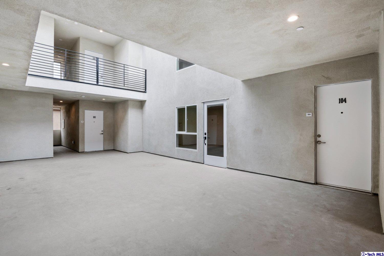 7064 Greeley Street, Unit 101 Tujunga, CA 91042 - Photo 9 of 37 an empty room with windows
