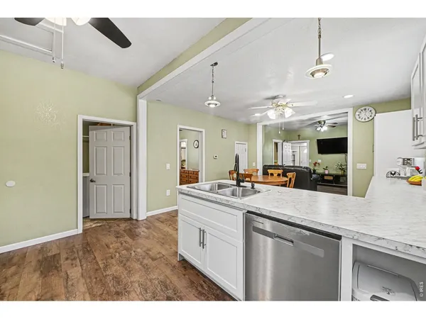 a kitchen with stainless steel appliances granite countertop a sink and white cabinets