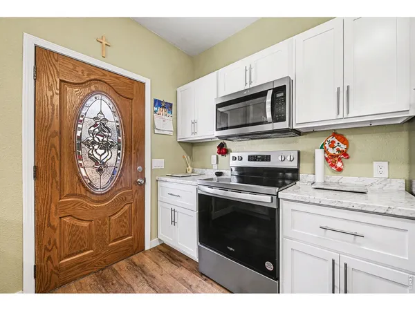 a kitchen with stainless steel appliances granite countertop a stove and a microwave