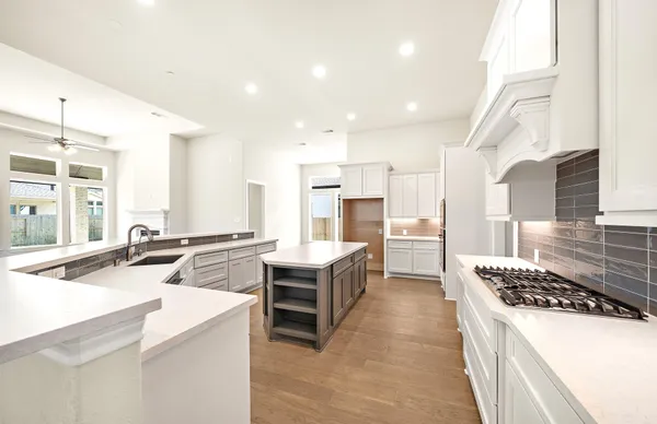a kitchen that has a sink and a stove