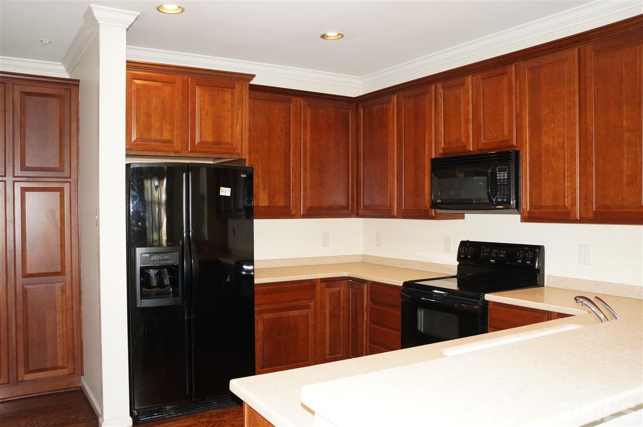 508 South Person Street, Unit 107 Raleigh, NC 27601 - Photo 13 of 24 a kitchen with stainless steel appliances granite countertop a refrigerator and a stove top oven