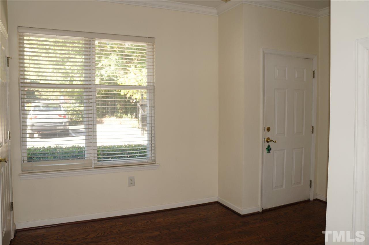 508 South Person Street, Unit 107 Raleigh, NC 27601 - Photo 15 of 24 a view of an empty room with wooden floor and a window